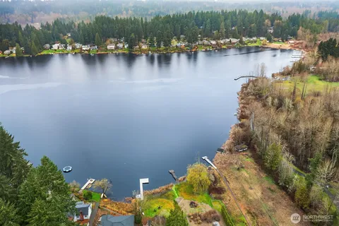 a view of a lake with boats and trees in the background