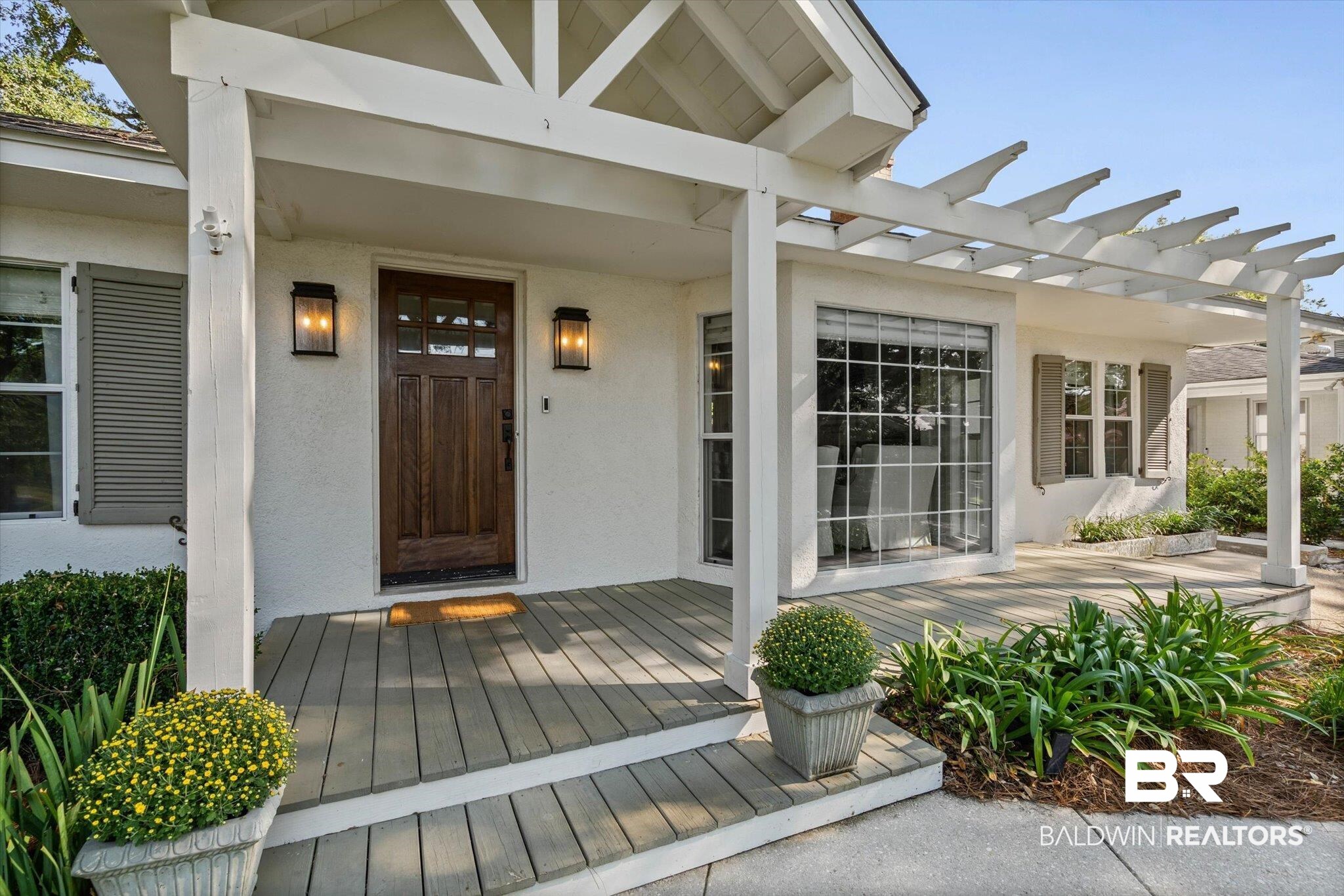 4310 The Cedars Avenue Mobile, AL 36608 - Photo 27 of 32 Doorway to property with stucco siding, a deck, and a pergola