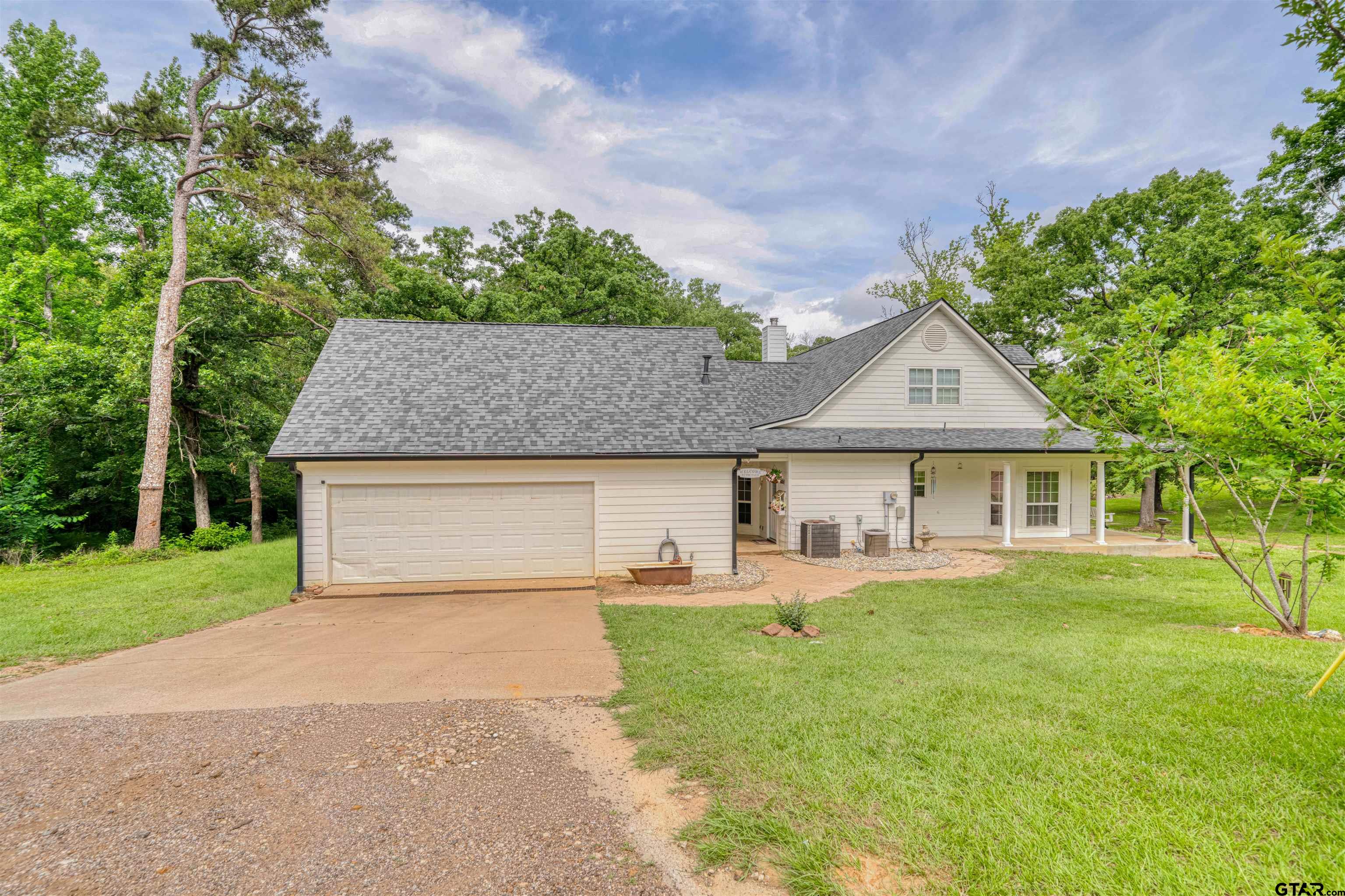 1776 Mustang Road Gilmer, TX 75645 - Photo 6 of 45 a front view of a house with a yard and trees