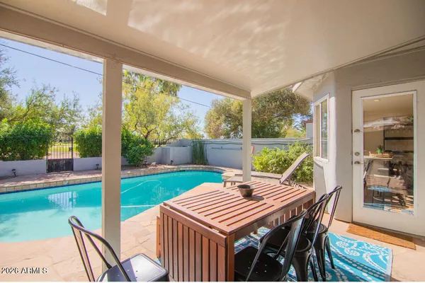 a view of an outdoor dining space with a table and chairs