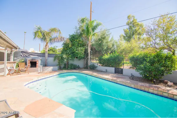a swimming pool with outdoor seating and yard