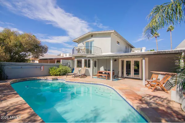 a view of a house with a yard patio and fire pit