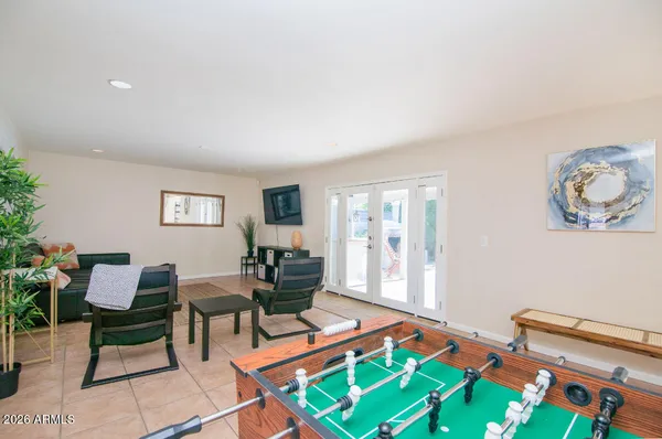 a living room with furniture a rug and a wall painting