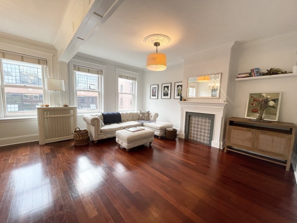 145 Charles Street, Unit 4 Boston, MA 02114 - Photo 1 of 24 a living room with furniture and a fireplace