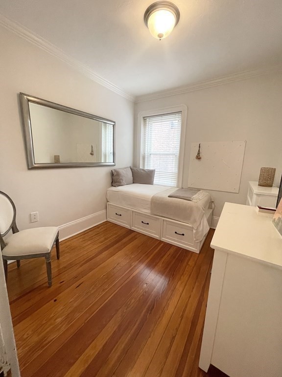 145 Charles Street, Unit 4 Boston, MA 02114 - Photo 11 of 24 a bedroom with a bed and wooden floor