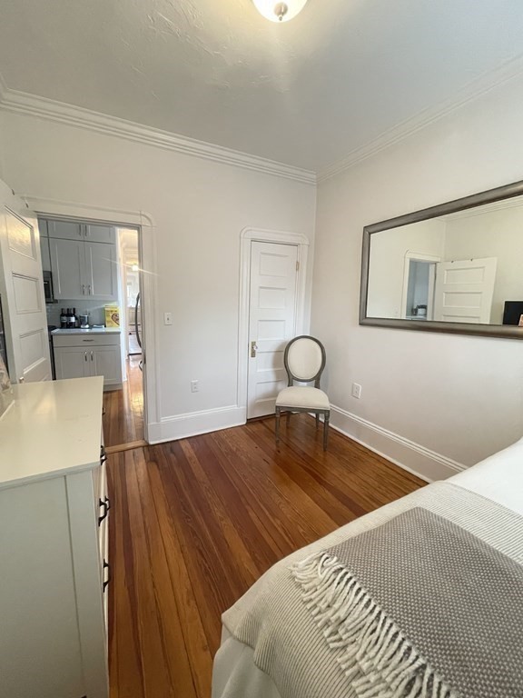 145 Charles Street, Unit 4 Boston, MA 02114 - Photo 12 of 24 a bedroom with a bed and wooden floor