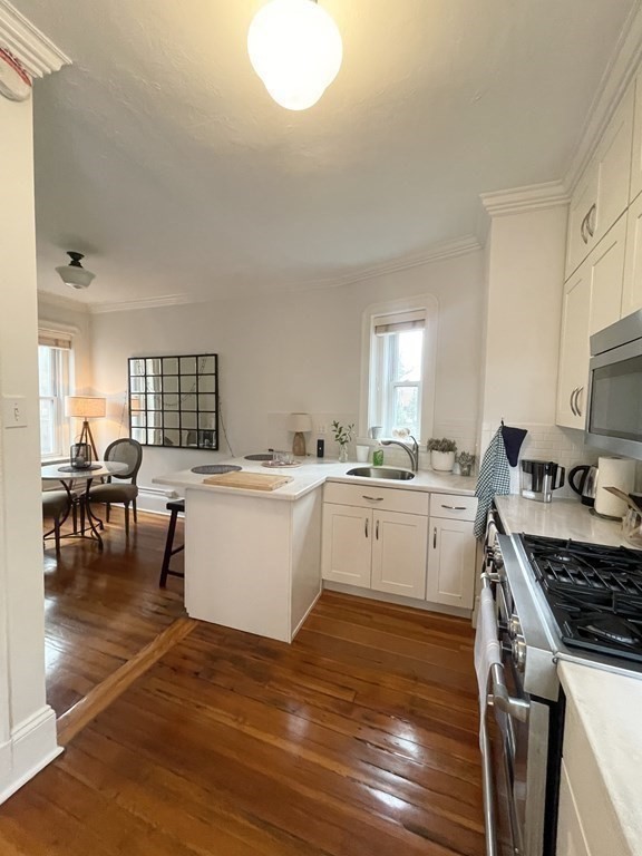 145 Charles Street, Unit 4 Boston, MA 02114 - Photo 16 of 24 a kitchen with a table chairs and a stove