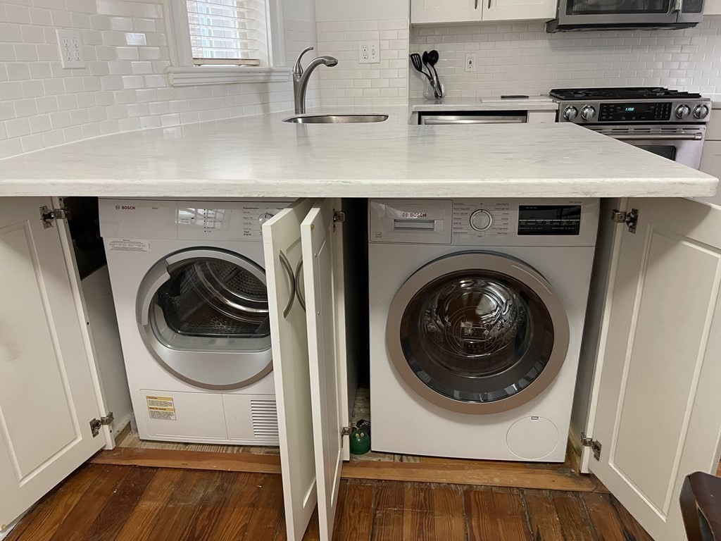 145 Charles Street, Unit 4 Boston, MA 02114 - Photo 18 of 24 a utility room with sink dryer and washer