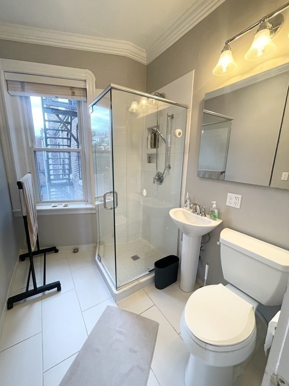 145 Charles Street, Unit 4 Boston, MA 02114 - Photo 22 of 24 a bathroom with a toilet sink and a shower