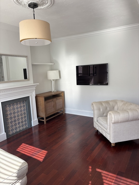 145 Charles Street, Unit 4 Boston, MA 02114 - Photo 6 of 24 a living room with furniture and a flat screen tv