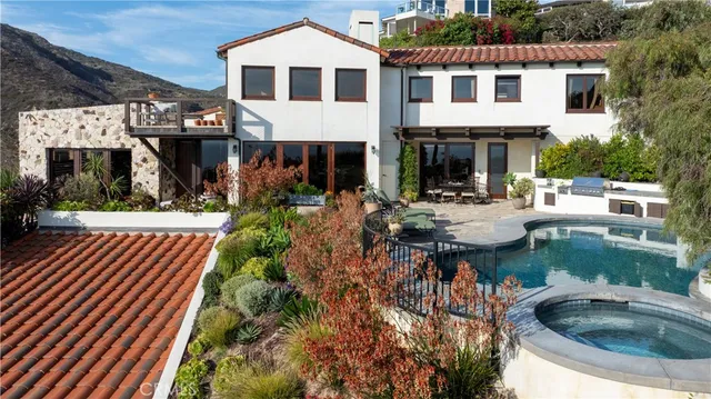 a view of a patio with table and chairs and potted plants