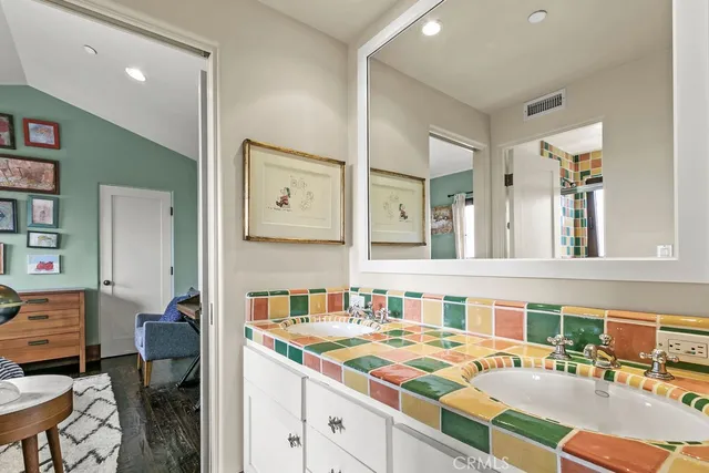 a bathroom with a double vanity sink a mirror and a shower