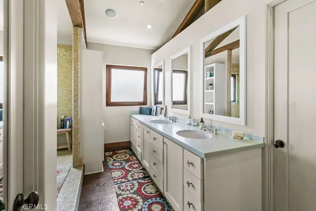 a bathroom with a sink a mirror and a bathtub