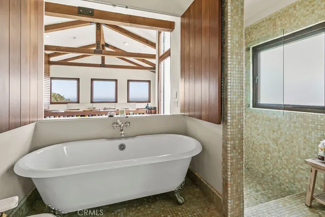 a outdoor space with patio couches and a fireplace