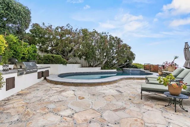 a kitchen with granite countertop a table chairs sink and cabinets