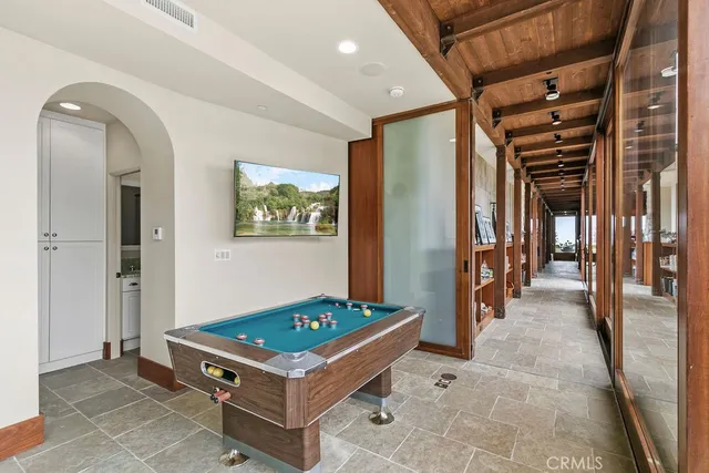 a kitchen with granite countertop a stove a sink a dining table and chairs