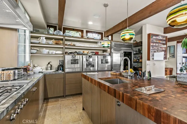 a utility room with a sink a washer and dryer with wooden floor