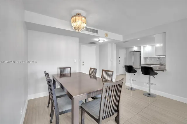 a kitchen with stainless steel appliances granite countertop a sink and a refrigerator