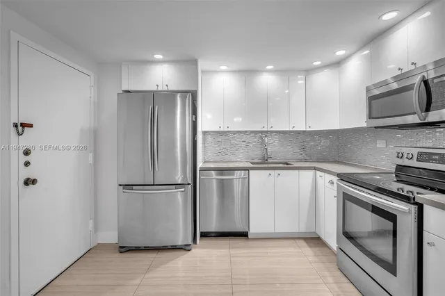 a kitchen with stainless steel appliances granite countertop a sink and cabinets