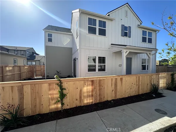 a view of a house with a wooden fence