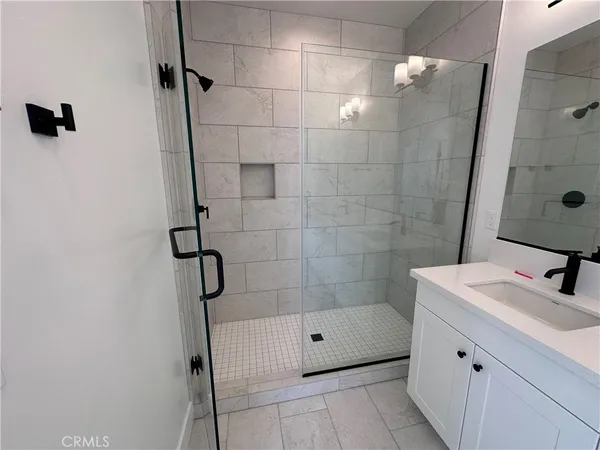 a bathroom with a double vanity sink toilet and shower