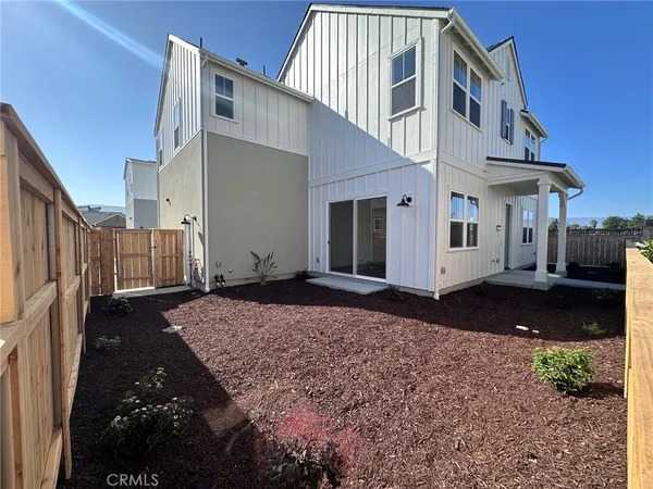 a view of a house with backyard and sitting area