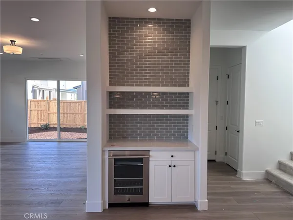 a view of kitchen with granite countertop cabinets and wooden floor