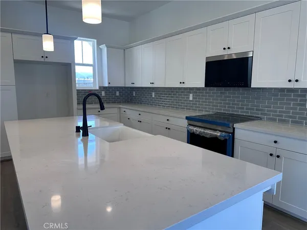 a kitchen with a sink and a stove