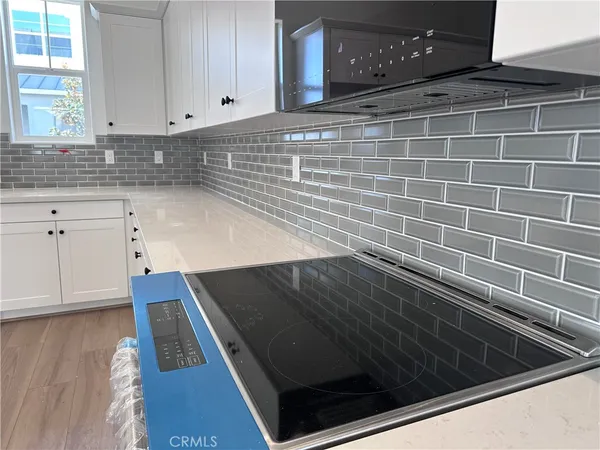 a kitchen with a stove a refrigerator and a sink