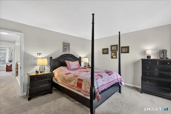 a bedroom with a bed a lamp and a large closet