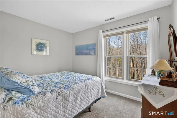 a bedroom with a bed and a window with outer view