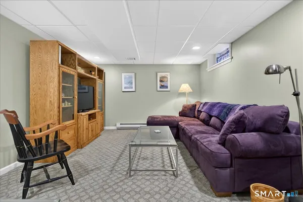 a living room with furniture and a rug