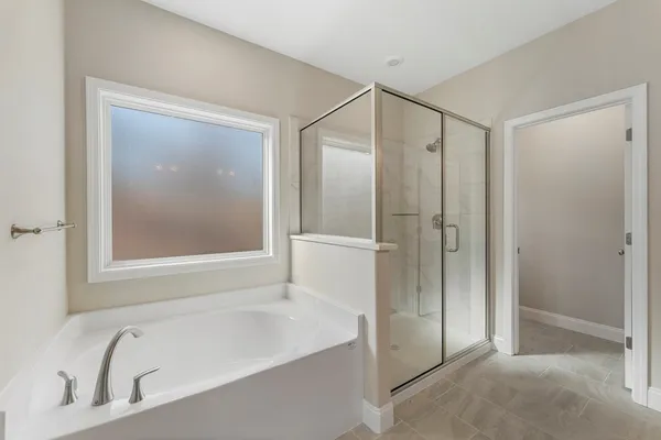 a bathroom with a bathtub and a shower