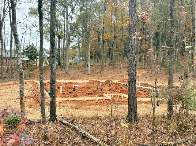 a view of a yard with wooden fence