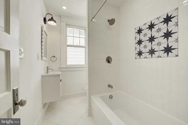 a bathroom with a bathtub and shower