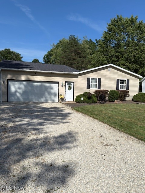 3868 Cook Road Rootstown, OH 44272 - Photo 44 of 44 View of front facade with gravel driveway, an attached garage, and a front lawn