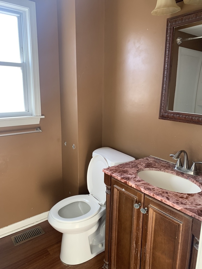 3637 Morgan Street Steger, IL 60475 - Photo 6 of 9 a bathroom with a granite countertop toilet sink and mirror