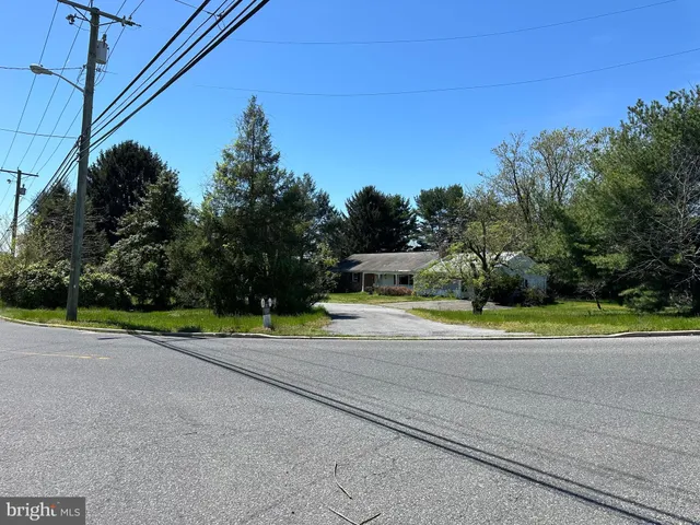 a view of a road with a big yard
