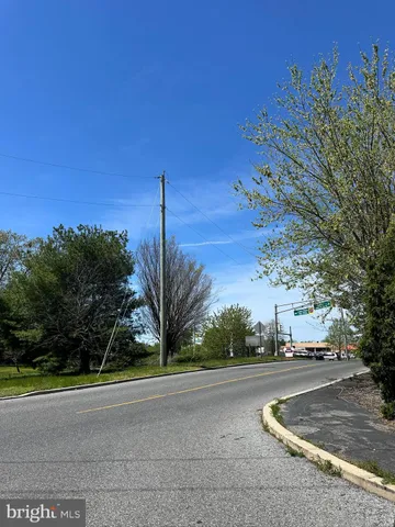 a view of a street with a building in the background