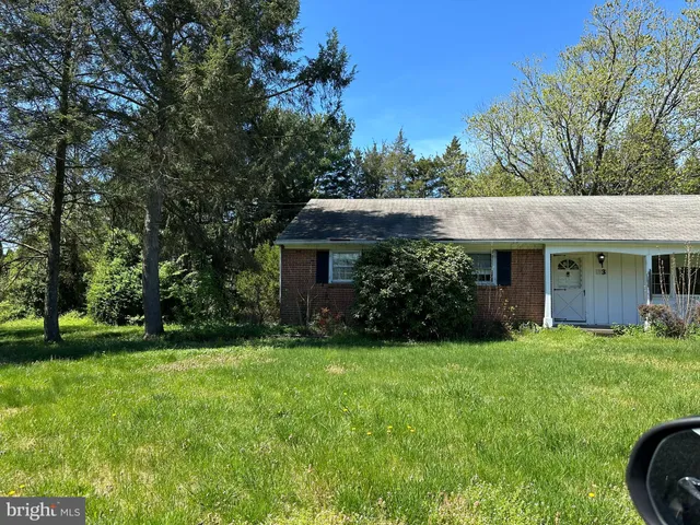 a view of a house with garden and yard