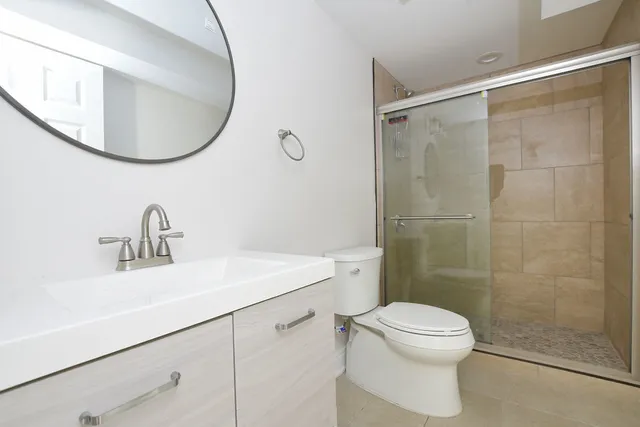 a bathroom with a sink toilet and a mirror