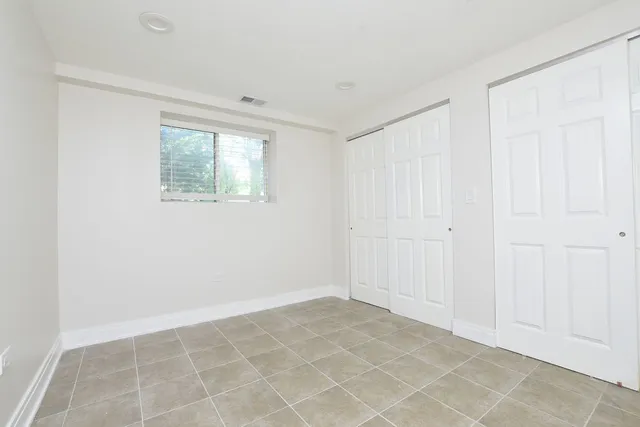 a view of yard with a big yard and potted plants