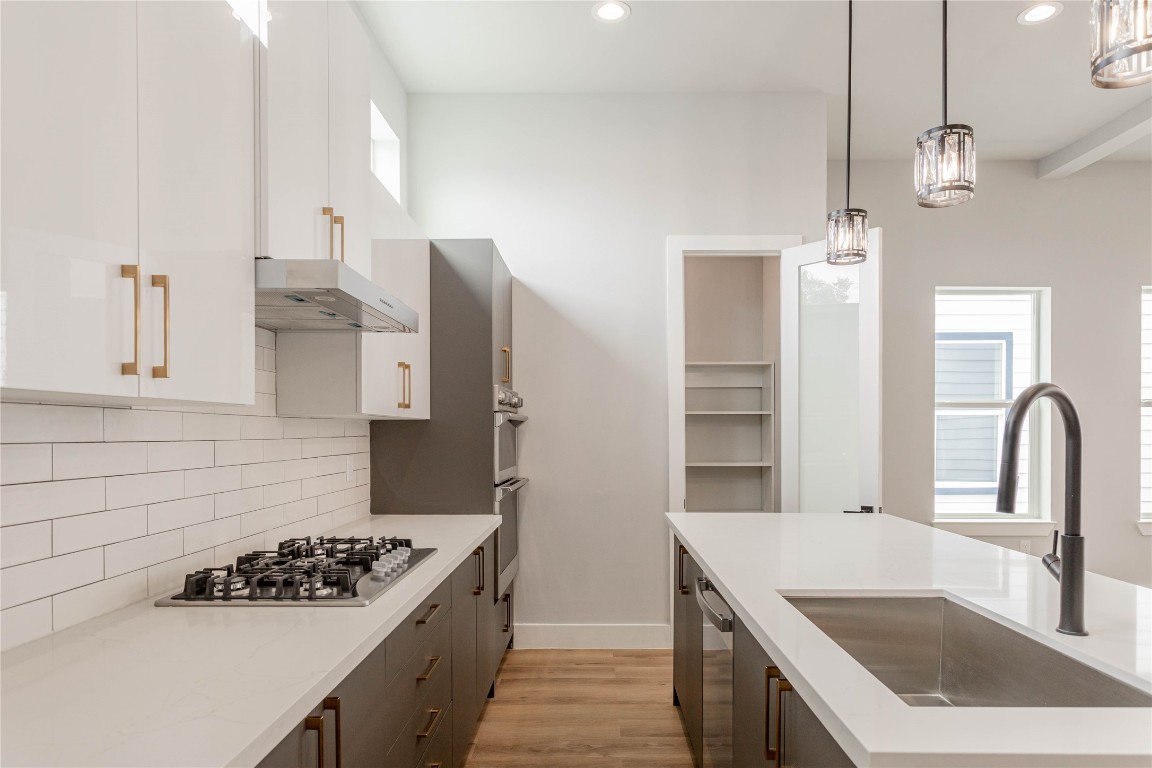 711 Boundary Street Houston, TX 77009 - Photo 12 of 26 a kitchen with stainless steel appliances granite countertop a sink stove and refrigerator