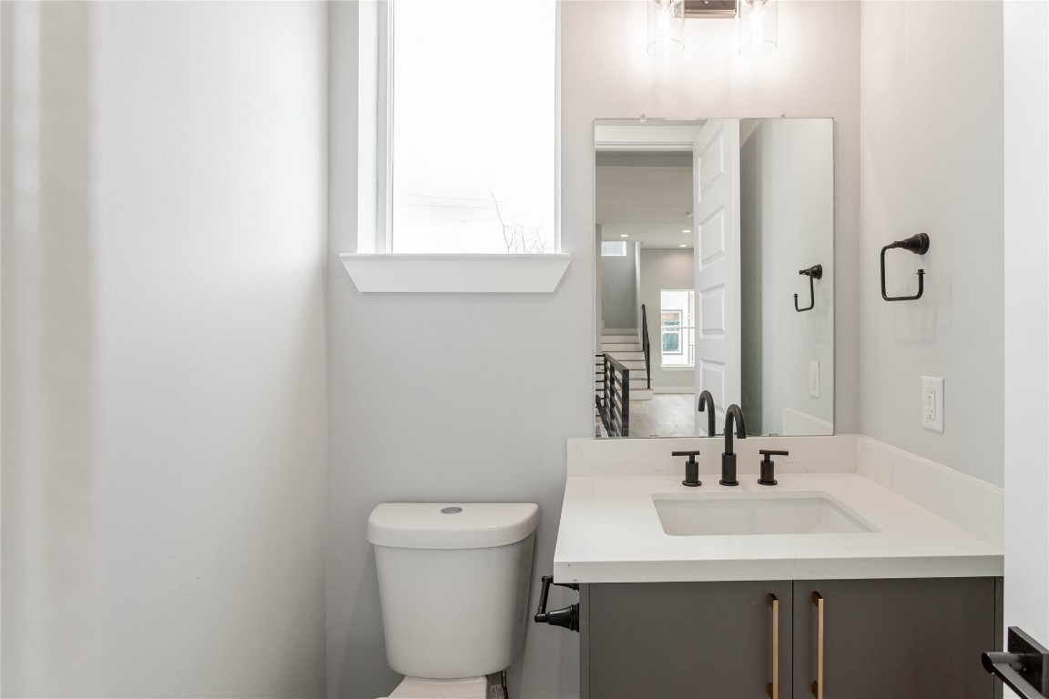 711 Boundary Street Houston, TX 77009 - Photo 14 of 26 a bathroom with a toilet sink and mirror