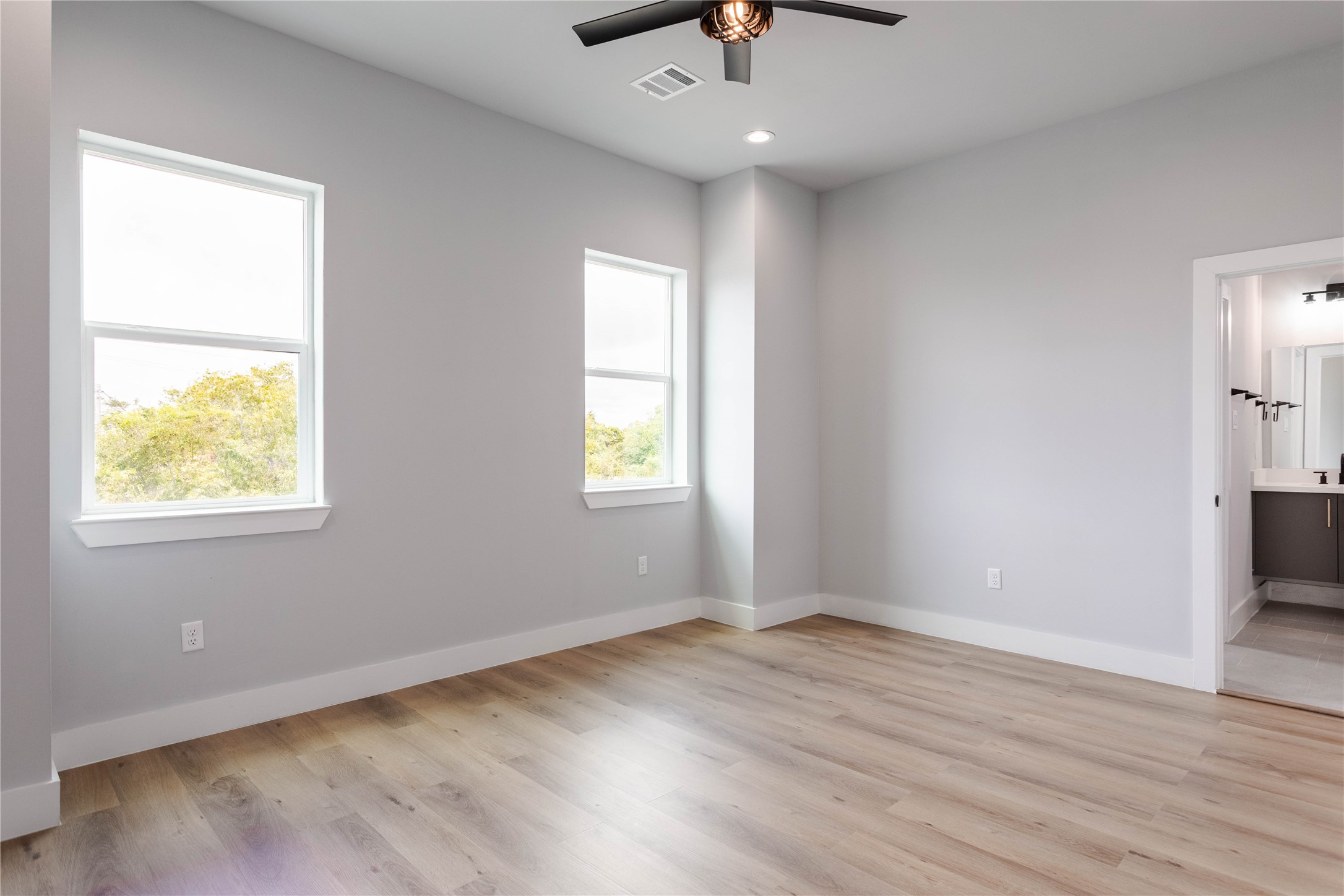 711 Boundary Street Houston, TX 77009 - Photo 18 of 26 wooden floor in an empty room with a window