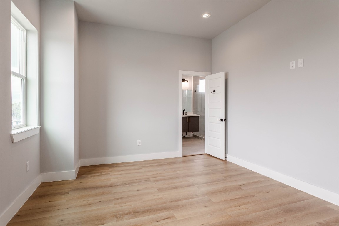 711 Boundary Street Houston, TX 77009 - Photo 19 of 26 a view of an empty room with wooden floor and a window