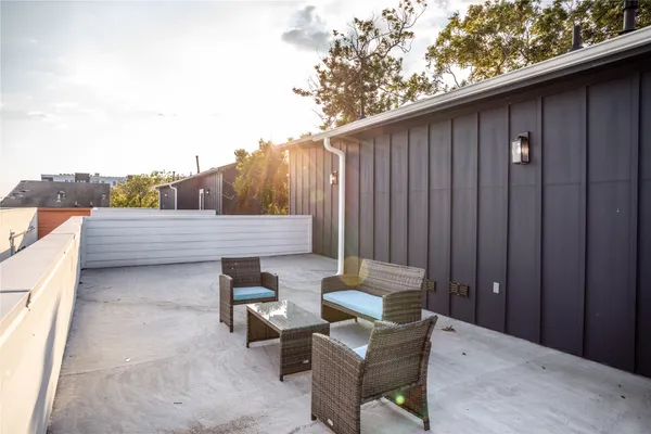 a backyard of a house with table and chairs