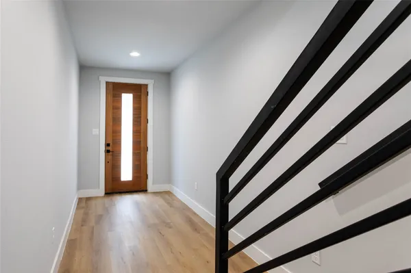 a view of a room with wooden floor and stairs