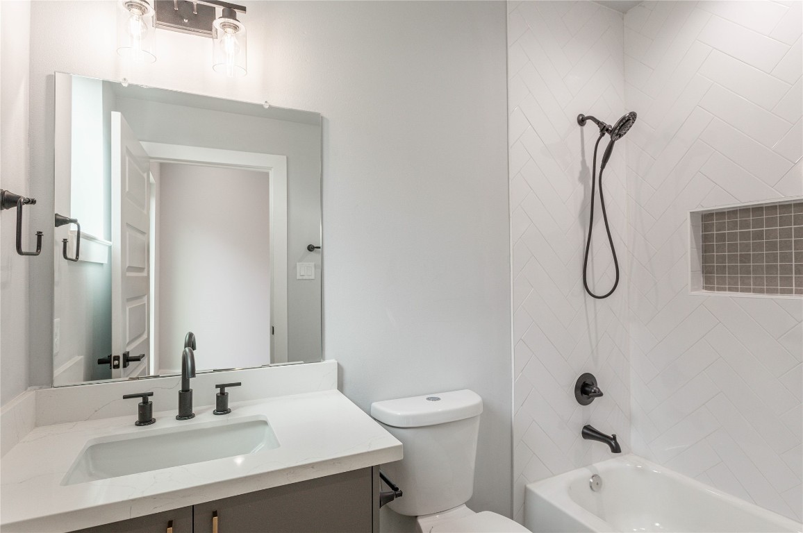 711 Boundary Street Houston, TX 77009 - Photo 6 of 26 a bathroom with a sink vanity tub and a toilet