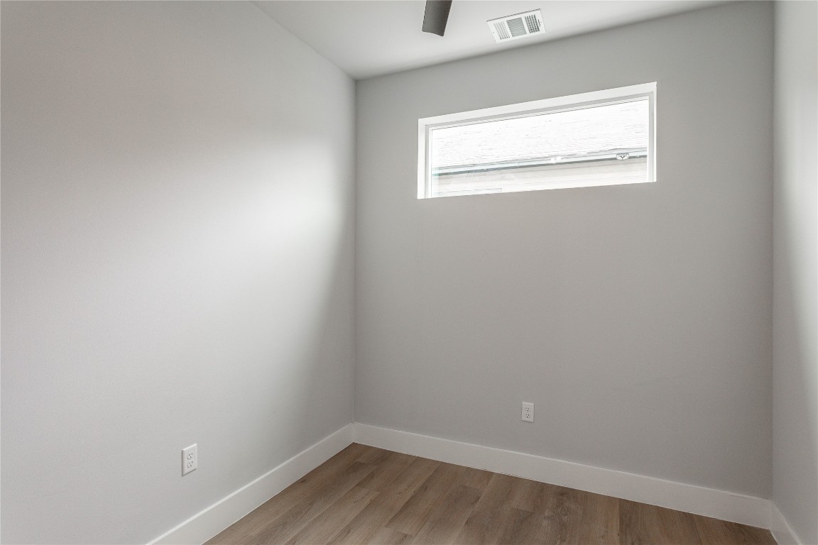 711 Boundary Street Houston, TX 77009 - Photo 7 of 26 a view of a small space with wooden floor and a window